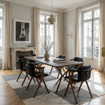 Dining room with wooden table and chairs, large windows, and decorative elements.